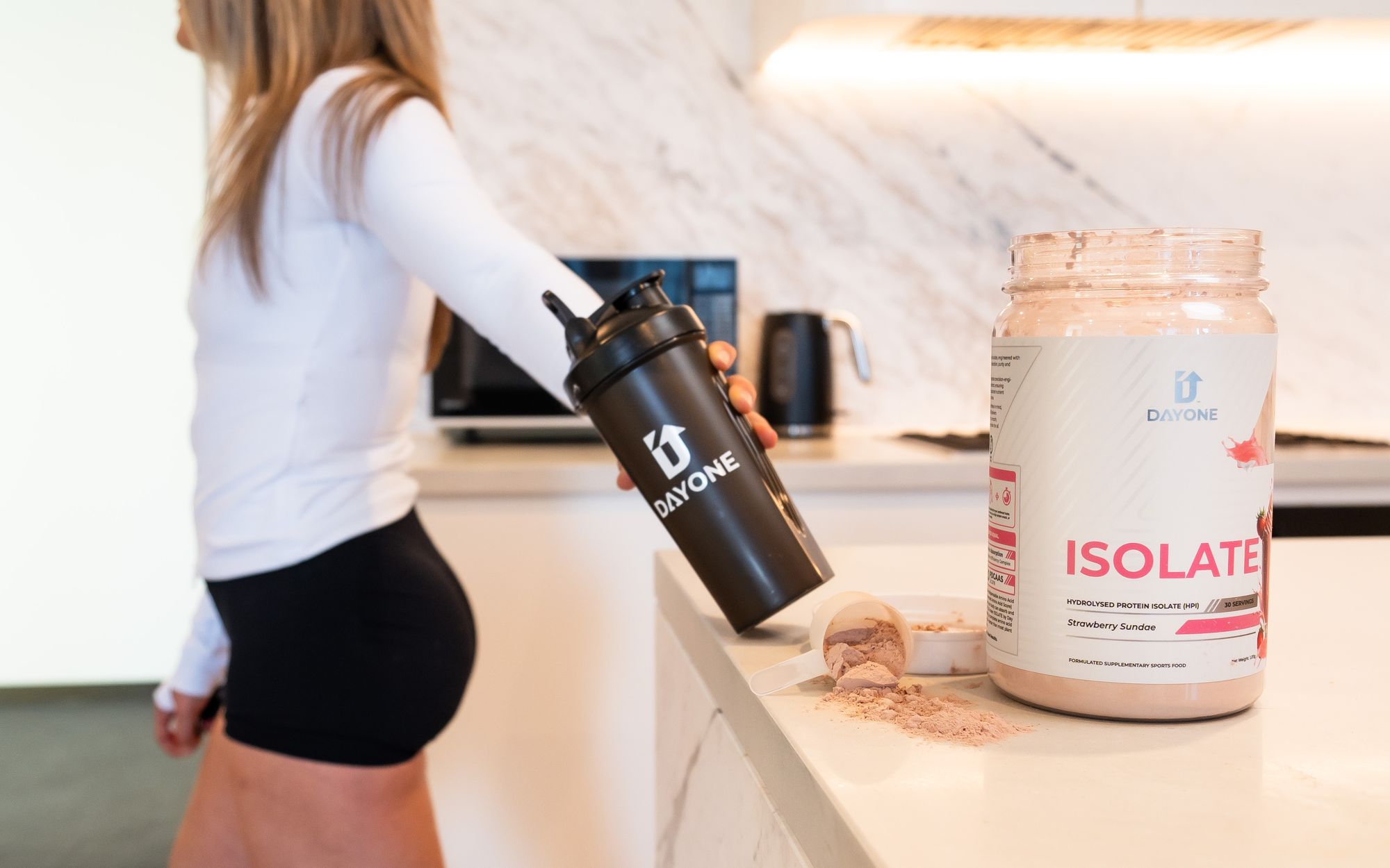 ISOLATE Strawberry Sundae tub and Day One shaker on a kitchen bench